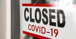 Closed businesses for COVID-19 pandemic outbreak, closure sign on retail store window banner background. Government shutdown of restaurants, shopping stores, non essential services