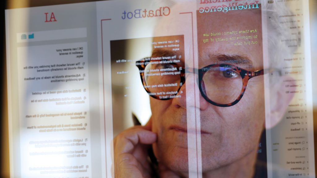 older female worker looking at screen with AI tools
