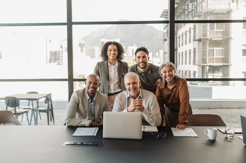 intergenerational work team sitting around computer